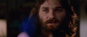 Movie still from “The Thing” (1982), directed by John Carpenter – A person with long hair and a beard; Close Up shot, Low angle