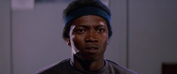 Movie still from “The Thing” (1982), directed by John Carpenter – A person wearing a headband; Close Up shot, Low angle