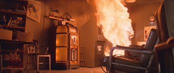 Movie still from “The Thing” (1982), directed by John Carpenter – An oven is on fire in a room; Wide shot, Low angle
