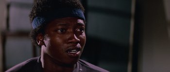 Movie still from “The Thing” (1982), directed by John Carpenter – A person wearing a headband; Close Up shot, Low angle