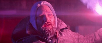 Movie still from “The Thing” (1982), directed by John Carpenter – A man with a beard is wearing a hooded jacket; Close Up shot, Low angle