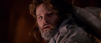 Movie still from “The Thing” (1982), directed by John Carpenter – A man with long hair and a long beard; Close Up shot, Low angle