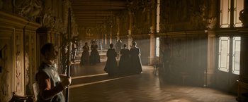 Movie still from “The Three Musketeers - Part I: D'Artagnan” (2023), directed by Martin Bourboulon – A group of people standing in a room; Extreme Wide shot, High angle