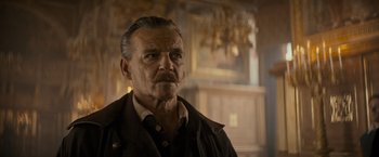 Movie still from “The Three Musketeers - Part I: D'Artagnan” (2023), directed by Martin Bourboulon – An older man with a mustache and a mustache comb; Close Up shot, Low angle