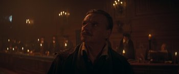 Movie still from “The Three Musketeers - Part I: D'Artagnan” (2023), directed by Martin Bourboulon – A man with a beard is looking up at the ceiling; Close Up shot, Low angle