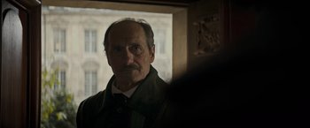 Movie still from “The Three Musketeers - Part I: D'Artagnan” (2023), directed by Martin Bourboulon – An older man with a mustache looking into a mirror; Close Up shot, Over the shoulder angle
