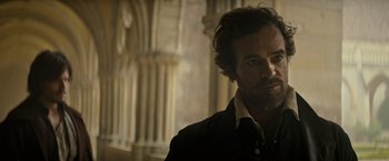 Movie still from “The Three Musketeers - Part I: D'Artagnan” (2023), directed by Martin Bourboulon – A person wearing a jacket; Close Up shot, Over the shoulder angle