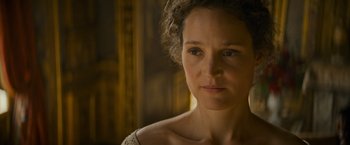 Movie still from “The Three Musketeers - Part I: D'Artagnan” (2023), directed by Martin Bourboulon – A person with curly hair; Close Up shot, Over the shoulder angle