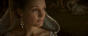 Movie still from “The Three Musketeers - Part I: D'Artagnan” (2023), directed by Martin Bourboulon – A woman's face in the dark; Close Up shot, Low angle