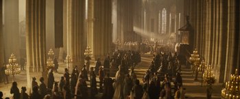 Movie still from “The Three Musketeers - Part I: D'Artagnan” (2023), directed by Martin Bourboulon – A large group of people gathered inside a church; Extreme Wide shot, High angle