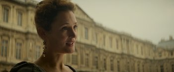 Movie still from “The Three Musketeers - Part I: D'Artagnan” (2023), directed by Martin Bourboulon – A person looking out of a window; Close Up shot, Over the shoulder angle