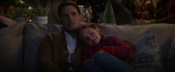 Movie still from “The Tomorrow War” (2021), directed by Chris McKay – A man and a little girl sitting on a couch; Medium shot, Over the shoulder angle