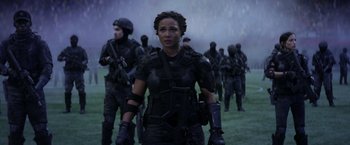 Movie still from “The Tomorrow War” (2021), directed by Chris McKay – A group of people in black clothing and helmets; Medium shot, Over the shoulder angle