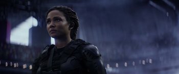 Movie still from “The Tomorrow War” (2021), directed by Chris McKay – A woman in a black outfit looking to her left; Close Up shot, Low angle