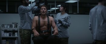 Movie still from “The Tomorrow War” (2021), directed by Chris McKay – A man sitting in a chair next to a woman; Medium shot, Over the shoulder angle