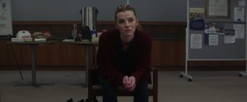 Movie still from “The Tomorrow War” (2021), directed by Chris McKay – A woman sitting on a chair in a room; Medium shot, High angle