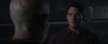 Movie still from “The Tomorrow War” (2021), directed by Chris McKay – A man standing in front of another man in a dark room; Close Up shot, Over the shoulder angle