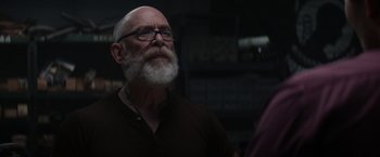 Movie still from “The Tomorrow War” (2021), directed by Chris McKay – An old man with a beard and glasses looking to his left; Close Up shot, Over the shoulder angle