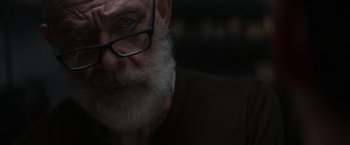 Movie still from “The Tomorrow War” (2021), directed by Chris McKay – An older man with a beard and glasses; Extreme Close Up shot, Low angle