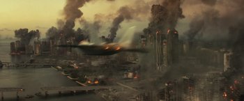 Movie still from “The Tomorrow War” (2021), directed by Chris McKay – An airplane flying over an industrial area filled with smoke and fire; Extreme Wide shot, High angle