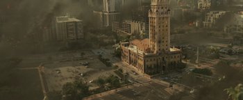 Movie still from “The Tomorrow War” (2021), directed by Chris McKay – An aerial view of a city with a tall building; Extreme Wide shot, High angle