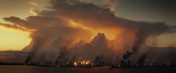 Movie still from “The Tomorrow War” (2021), directed by Chris McKay – A view of a city with a lot of smoke coming out of the sky; Extreme Wide shot, Low angle