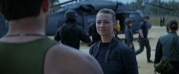 Movie still from “The Tomorrow War” (2021), directed by Chris McKay – A woman standing in front of a group of people; Close Up shot, Over the shoulder angle