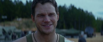 Movie still from “The Tomorrow War” (2021), directed by Chris McKay – A man smiling for the camera; Close Up shot, Over the shoulder angle