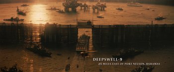 Movie still from “The Tomorrow War” (2021), directed by Chris McKay – An oil rig in the middle of the ocean with an airplane in the foreground; Extreme Wide shot, High angle