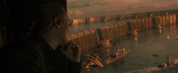 Movie still from “The Tomorrow War” (2021), directed by Chris McKay – A man with a headset looking out a window at the ocean; Medium shot, Over the shoulder angle