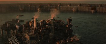Movie still from “The Tomorrow War” (2021), directed by Chris McKay – An oil refinery is near a large body of water; Extreme Wide shot, High angle