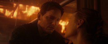 Movie still from “The Tomorrow War” (2021), directed by Chris McKay – A man and a woman in front of a burning building; Close Up shot, Over the shoulder angle