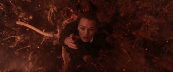 Movie still from “The Tomorrow War” (2021), directed by Chris McKay – A woman is laying on the ground in a pile of leaves; Medium shot, Overhead angle