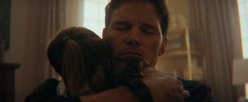 Movie still from “The Tomorrow War” (2021), directed by Chris McKay – A man and a woman hugging each other in a darkened room; Close Up shot, Over the shoulder angle