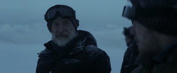 Movie still from “The Tomorrow War” (2021), directed by Chris McKay – A man with a white beard wearing goggles and a black jacket; Close Up shot, Over the shoulder angle