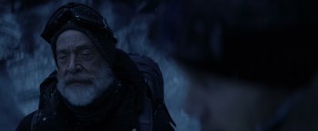 Movie still from “The Tomorrow War” (2021), directed by Chris McKay – A man with a beard is smoking in the dark; Close Up shot, Over the shoulder angle