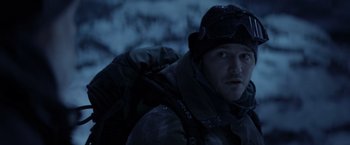 Movie still from “The Tomorrow War” (2021), directed by Chris McKay – A man with a backpack in the snow at night; Close Up shot, Over the shoulder angle