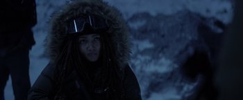 Movie still from “The Tomorrow War” (2021), directed by Chris McKay – A person with dreadlocks wearing a jacket and a hood; Close Up shot, Low angle