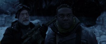Movie still from “The Tomorrow War” (2021), directed by Chris McKay – A man holding a rifle in the snow; Close Up shot, Over the shoulder angle
