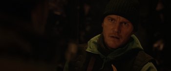 Movie still from “The Tomorrow War” (2021), directed by Chris McKay – A person wearing a jacket and a hat; Close Up shot, Over the shoulder angle