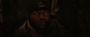 Movie still from “The Tomorrow War” (2021), directed by Chris McKay – A person wearing a jacket and a hat; Close Up shot, Low angle