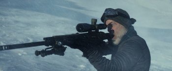 Movie still from “The Tomorrow War” (2021), directed by Chris McKay – A man with a rifle looking through a scope; Medium shot, Over the shoulder angle