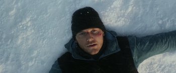 Movie still from “The Tomorrow War” (2021), directed by Chris McKay – A person laying in the snow; Close Up shot, Overhead angle