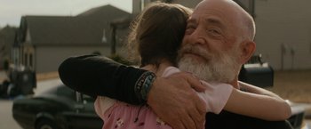 Movie still from “The Tomorrow War” (2021), directed by Chris McKay – An older man holding a young girl in his arms; Close Up shot, Over the shoulder angle