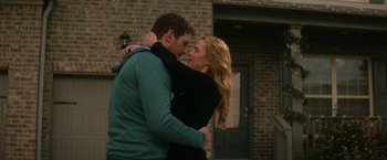 Movie still from “The Tomorrow War” (2021), directed by Chris McKay – A man and a woman hugging outside of a house; Medium shot, Over the shoulder angle