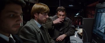 Movie still from “The Tourist” (2010), directed by Florian Henckel von Donnersmarck – Two men sitting in front of each other and one is smoking a cigarette; Medium shot, Over the shoulder angle