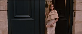 Movie still from “The Tourist” (2010), directed by Florian Henckel von Donnersmarck – A woman standing in front of a black door; Medium shot, Over the shoulder angle