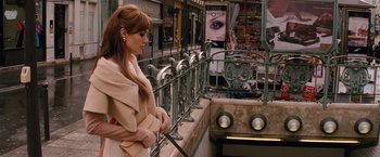 Movie still from “The Tourist” (2010), directed by Florian Henckel von Donnersmarck – A woman standing next to a railing on a sidewalk; Medium shot, Over the shoulder angle
