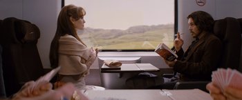 Movie still from “The Tourist” (2010), directed by Florian Henckel von Donnersmarck – A woman sitting in front of a window on a train; Medium shot, Over the shoulder angle