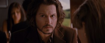 Movie still from “The Tourist” (2010), directed by Florian Henckel von Donnersmarck – A person with long hair and a beard; Close Up shot, Over the shoulder angle